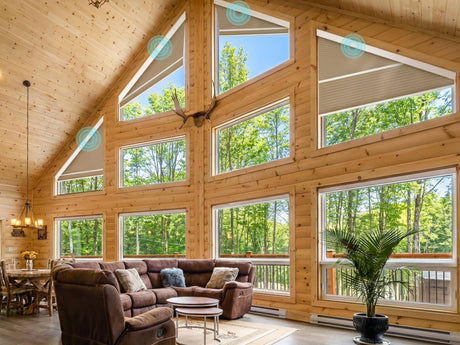 Motorized shades installed on a triangular window in a spacious modern interior.
