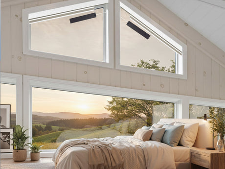 Motorized smart shades installed on large floor-to-ceiling bedroom windows in a modern home.